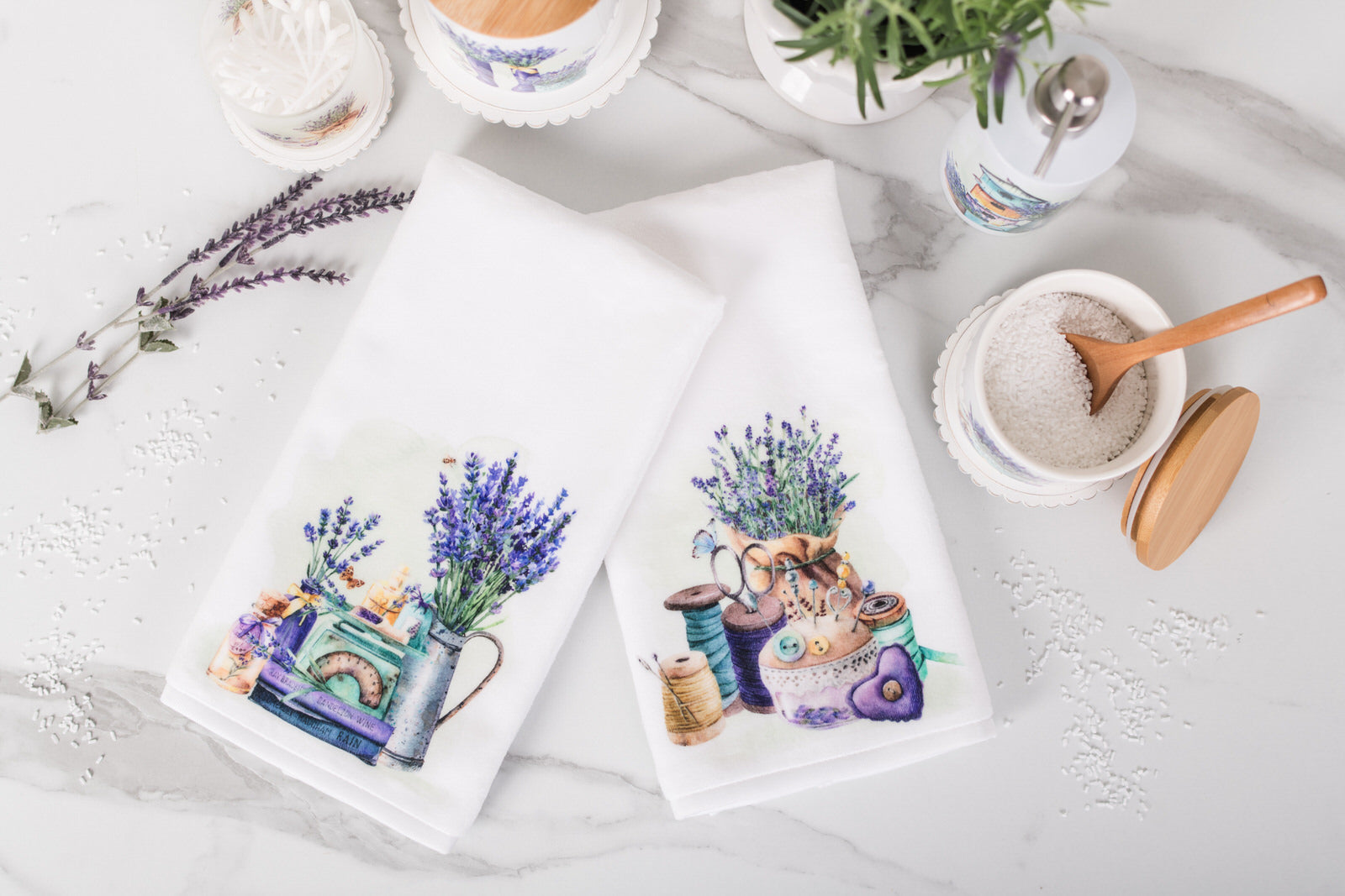 Two decorative towels with floral and cat designs on a white surface.