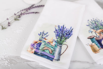 Two folded towels with floral designs on a marble surface