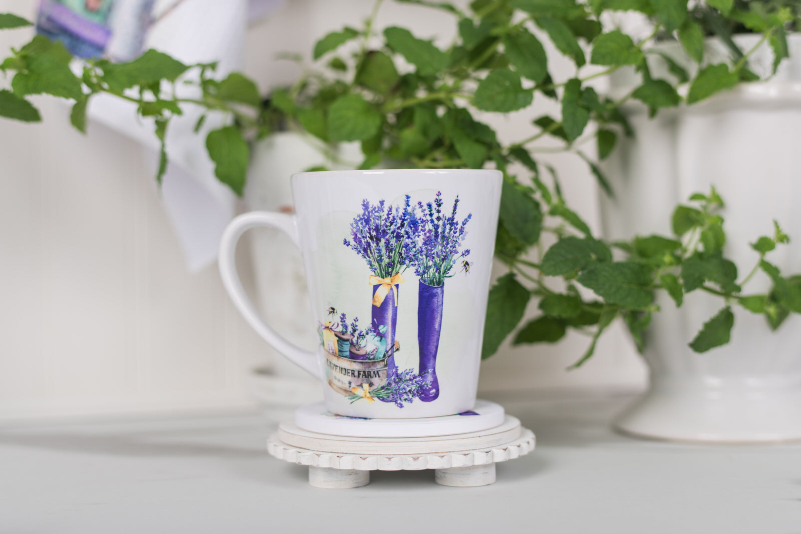 Mug with lavender design on a white surface with greenery in the background