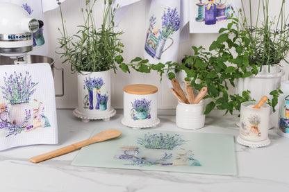 Kitchen counter with herbs, utensils, and decorative items on a white countertop.