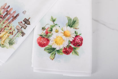 Floral and strawberry design on a white hand towel