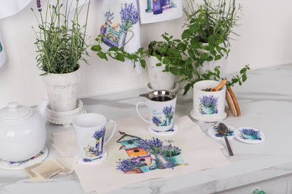 Tea set with mugs, teapot, and coasters featuring nature-themed designs on a white surface.