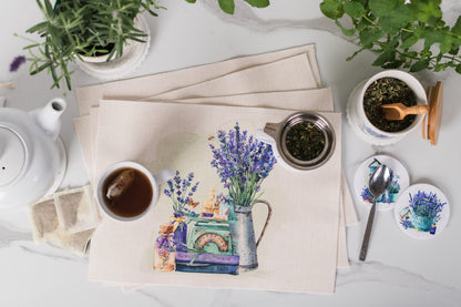 Tea set with lavender-themed coasters on a white surface