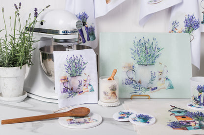 Kitchen scene with lavender-themed decor including towels, coasters, and a painting.