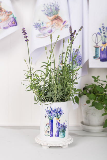 Potted plant with lavender in a watercolour pot on a white surface