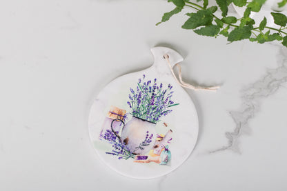 Round ceramic tray with floral design on a marble surface