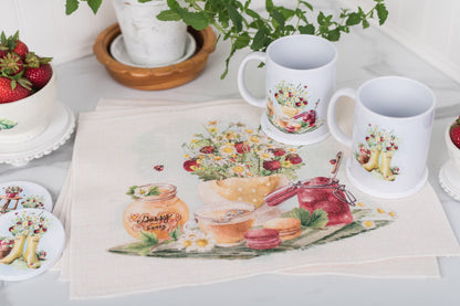 Set of four strawberry placemats on a farmhouse summer table.