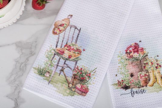 Watercolour strawberry tea towel in a cottage-style summer counter top.