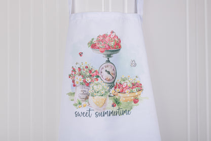 Cottage apron with watercolour strawberries and daisies, perfect for summer baking.