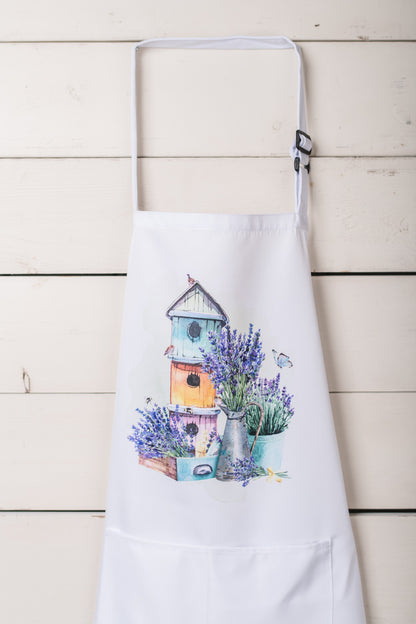 adult apron featuring lavender design  hanging on a white wall