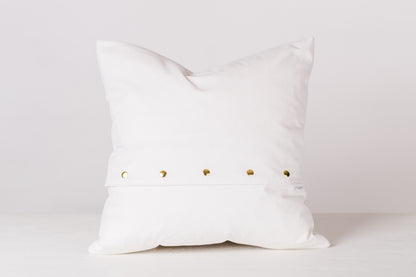 back of white pillow against a white background 