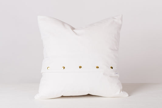 back of white pillow against a white background 